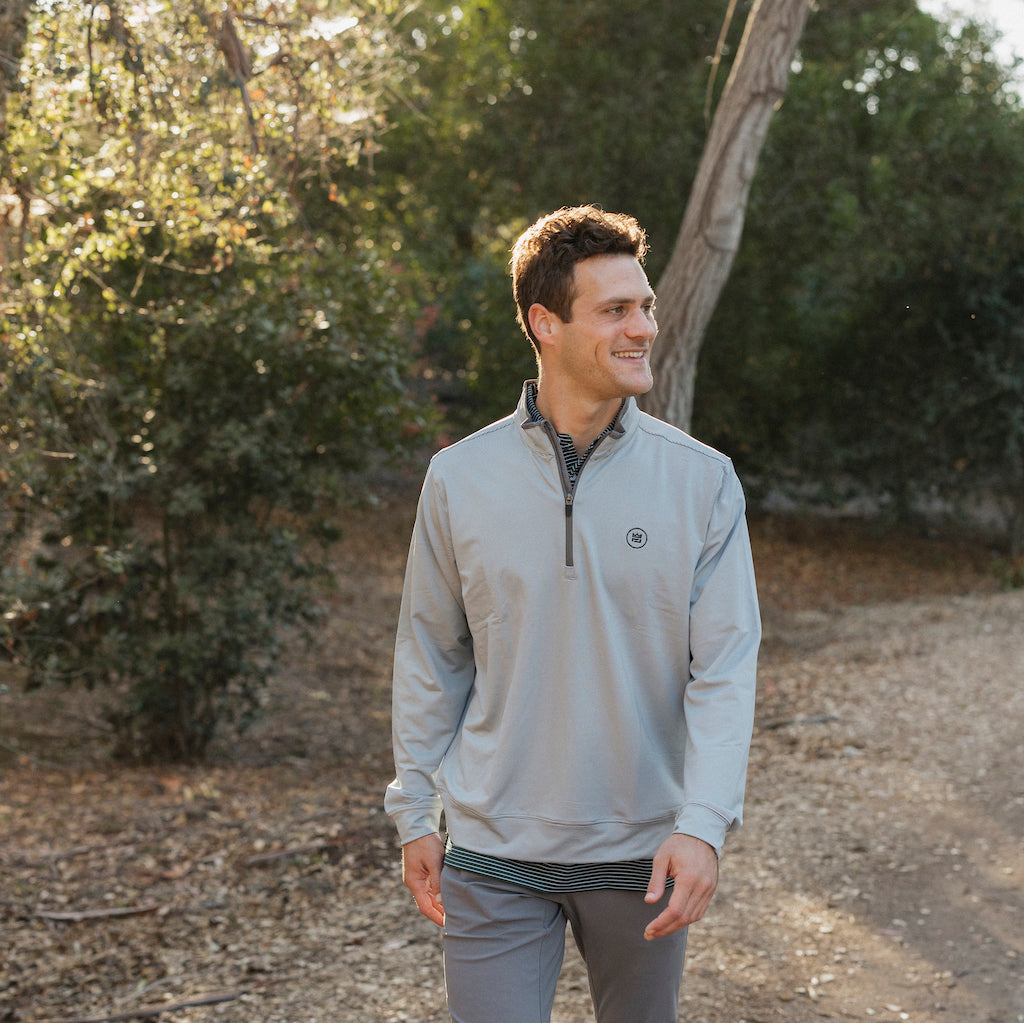 The Grey Quarter Zip outerwear piece features a subtle stripe pattern that flatters all and pairs with your favorite golf polo. It's breathability and stretch properties provide optimal mobility from the office to a night out.