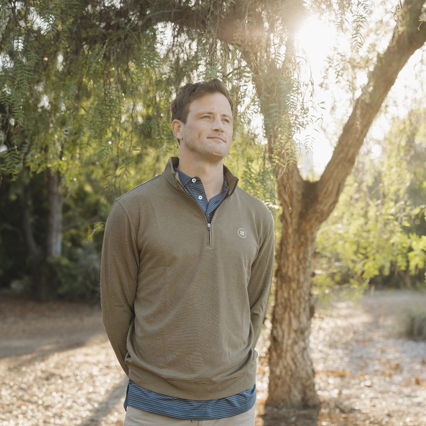This black and khaki striped quarter zip style outerwear piece features a buttery material.