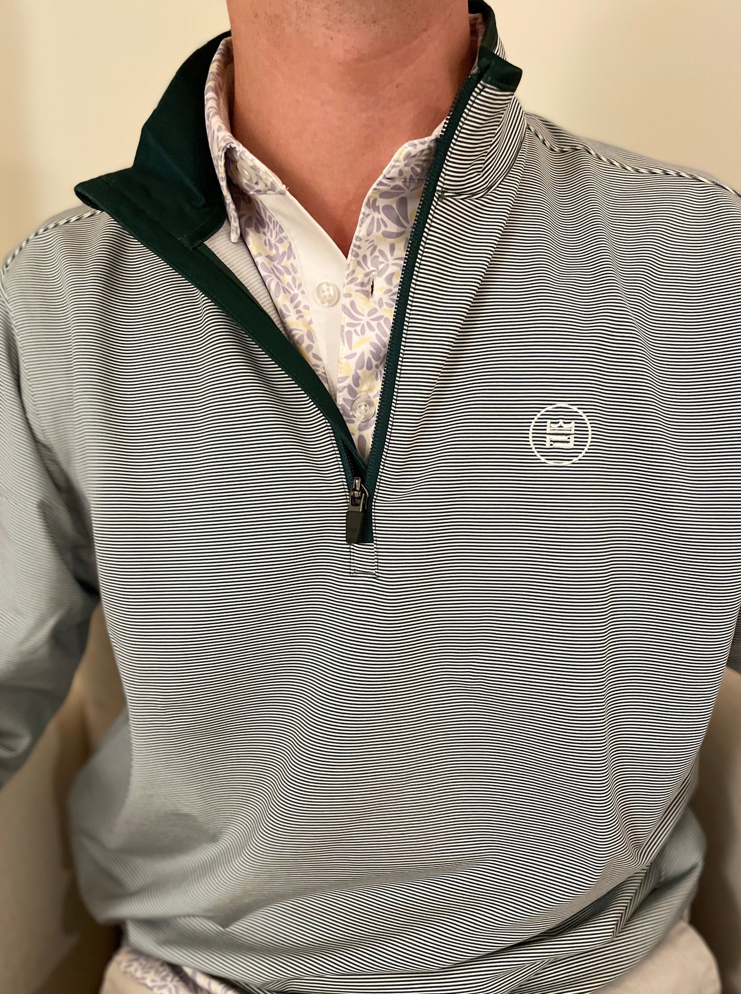 The long-sleeve Hunter Quarter zip outerwear piece features a crisp hunter green and white stripe color combination. It's breathability and stretch properties provide optimal mobility from the office to a night out.