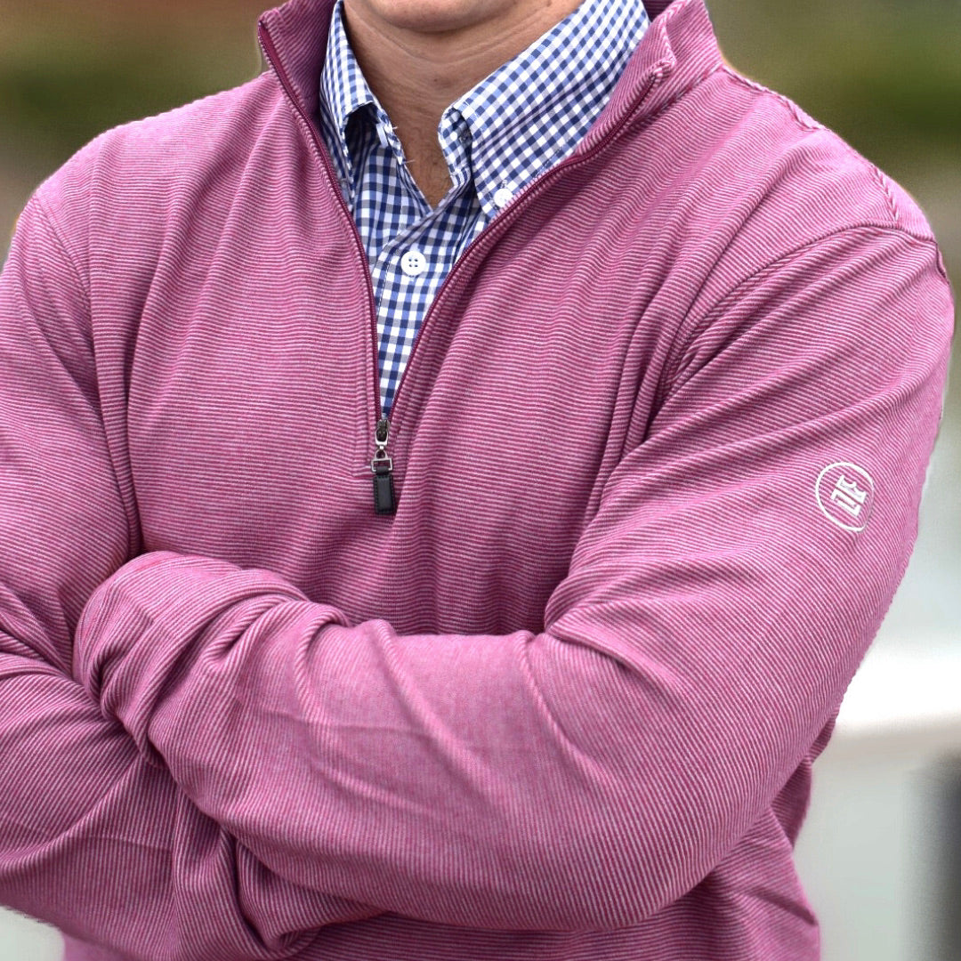 The Crimson Quarter Zip features a warm red and subtle silver stripe combination. It's breathability and stretch properties provide optimal mobility.