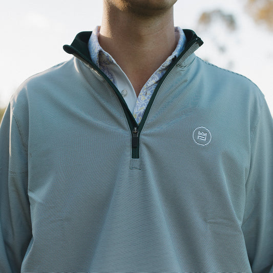 The long-sleeve Hunter Quarter zip outerwear piece features a crisp hunter green and white stripe color combination. It's breathability and stretch properties provide optimal mobility from the office to a night out.