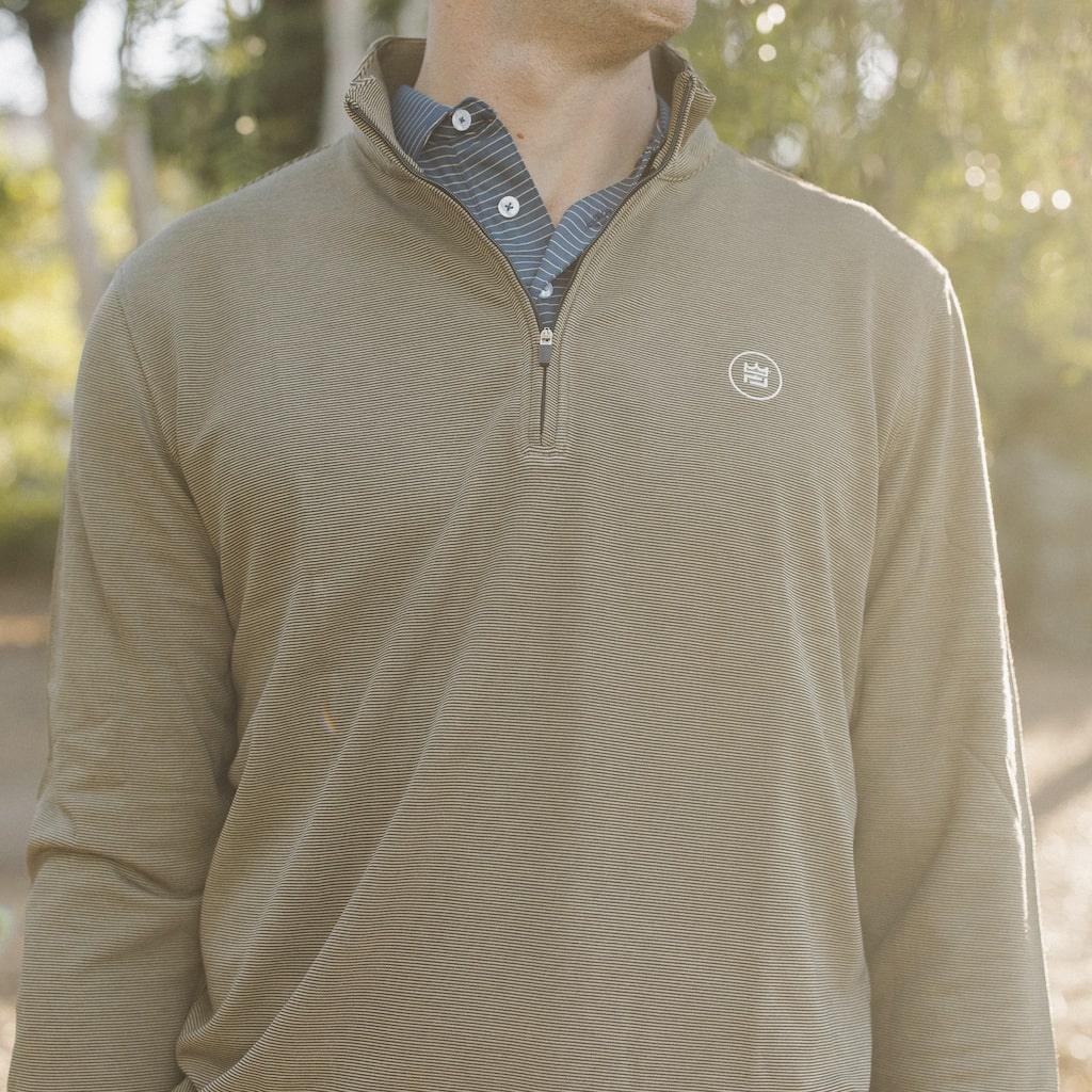 This black and khaki striped quarter zip style outerwear piece features a buttery material.