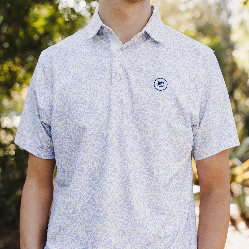 The Lilac Polo is a floral performance golf polo with an elevated material and aesthetic to up your style. The soft purple and yellow floral print flatters all.