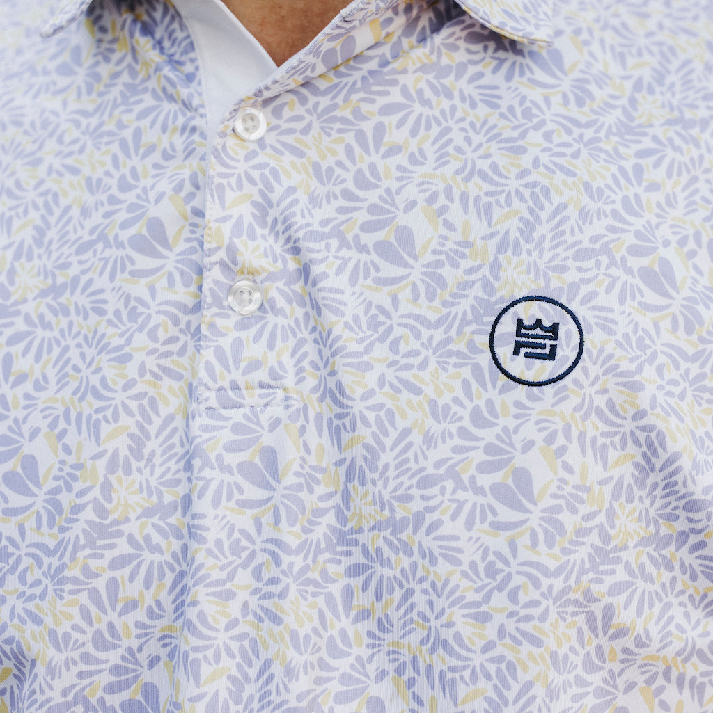 The Lilac Polo is a floral performance golf polo with an elevated material and aesthetic to up your style. The soft purple and yellow floral print flatters all.