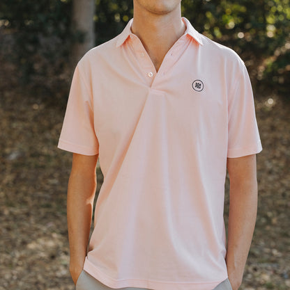 The Lion & Lamb Co. solid colored Salmon Polo features a breezy pique material and a sport fit.