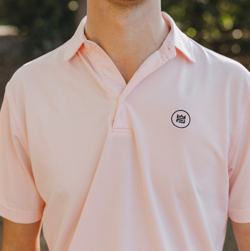 The Lion & Lamb Co. solid colored Salmon Polo features a breezy pique material and a sport fit.