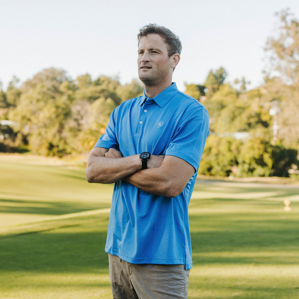 The Lion & Lamb Co. solid colored Sea Blue Polo features a breezy pique material and a sport fit.