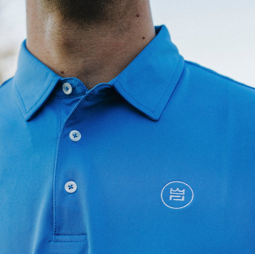 The Lion & Lamb Co. solid colored Sea Blue Polo features a breezy pique material and a sport fit.