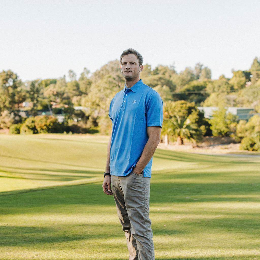 The Lion & Lamb Co. solid colored Sea Blue Polo features a breezy pique material and a sport fit.
